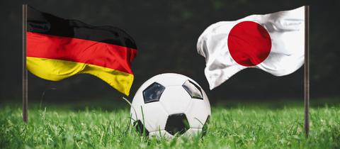 Deutsche und japanische Flagge mit Fußball in der Mitte